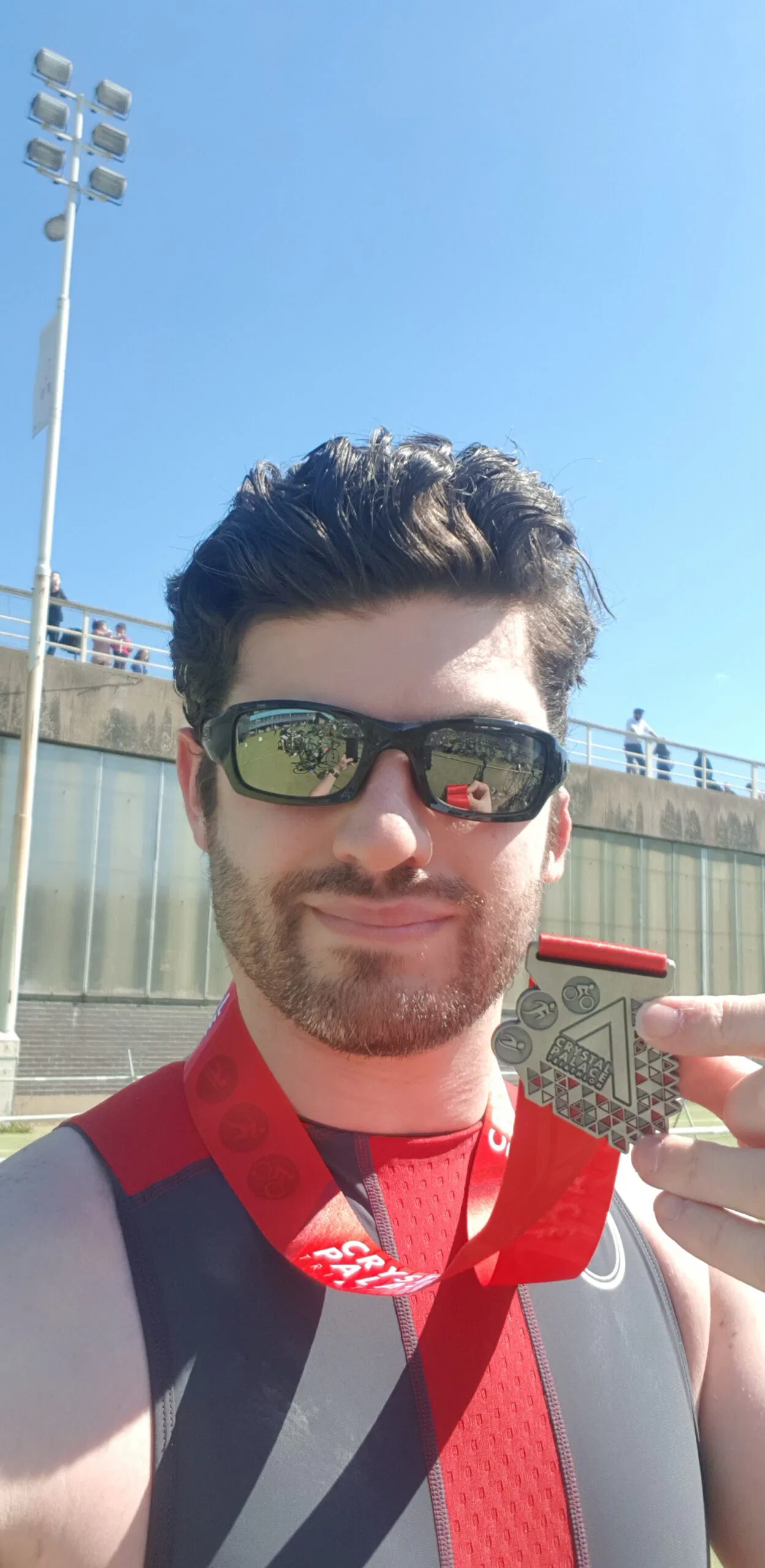 Coach Neal M. Brown holding finishers' medal